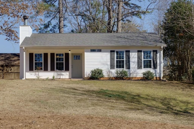 single story home featuring roof with shingles, a chimney, a front yard, and fence