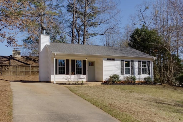 ranch-style home with a shingled roof, a chimney, a front yard, and fence