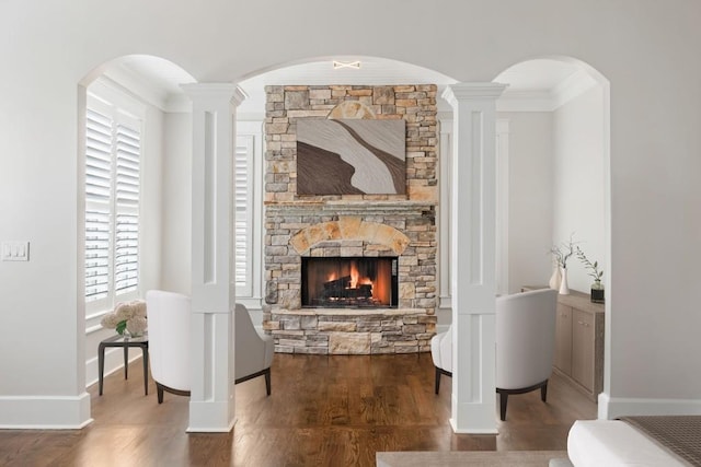 47 Fern Leaf Way, Newnan, GA 30265 - living room featuring a stone fireplace, wood finished floors, ornamental molding, and baseboards