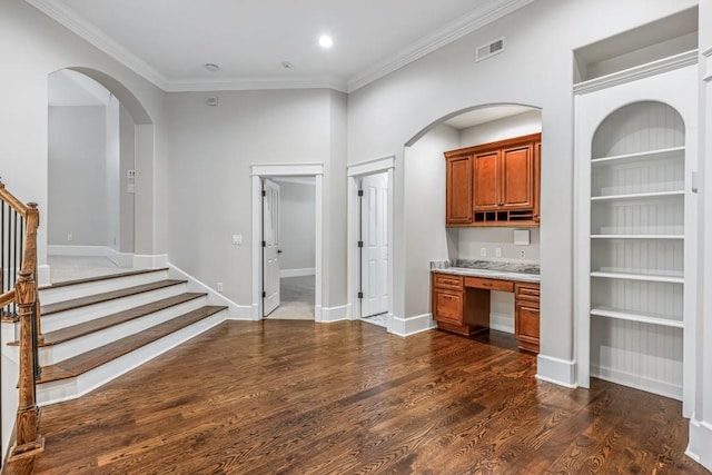 47 Fern Leaf Way, Newnan, GA 30265 - bar area featuring ornamental molding, stairs, arched walkways, dark wood-style flooring, and built in shelves