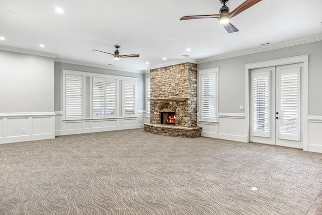 47 Fern Leaf Way, Newnan, GA 30265 - unfurnished living room with a ceiling fan, carpet flooring, crown molding, a decorative wall, and a fireplace
