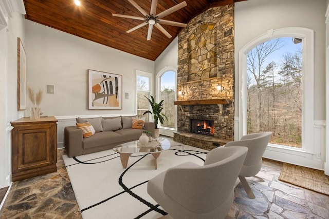 47 Fern Leaf Way, Newnan, GA 30265 - living room featuring wooden ceiling, dark stone finish floors, a stone fireplace, ceiling fan, and high vaulted ceiling