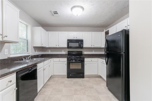 3732 Landgraf Cv, Decatur, GA 30034 - kitchen with black appliances, white cabinets, a sink, and a textured ceiling
