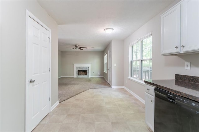 3732 Landgraf Cv, Decatur, GA 30034 - kitchen featuring black dishwasher, dark countertops, a fireplace, ceiling fan, and white cabinets