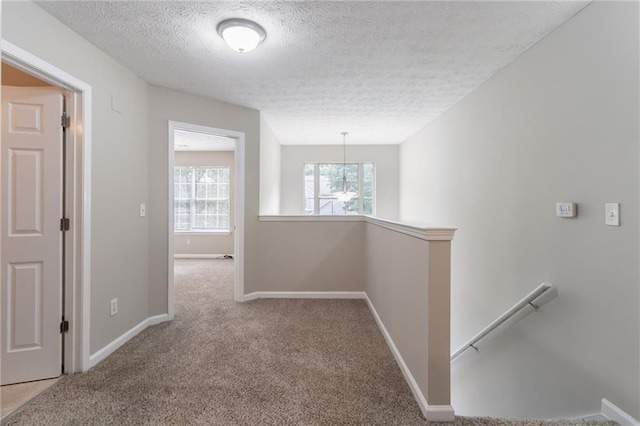 3732 Landgraf Cv, Decatur, GA 30034 - hall featuring an upstairs landing, a textured ceiling, carpet floors, baseboards, and a chandelier