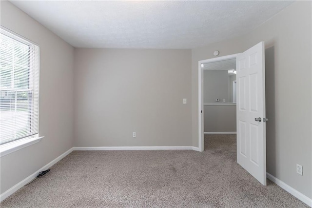 3732 Landgraf Cv, Decatur, GA 30034 - empty room with light colored carpet, baseboards, and a textured ceiling