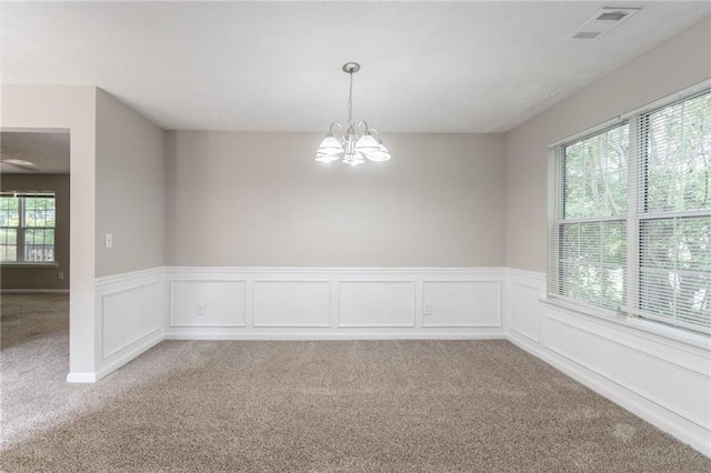 3732 Landgraf Cv, Decatur, GA 30034 - empty room featuring light colored carpet, a chandelier, and a wainscoted wall