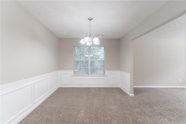 3732 Landgraf Cv, Decatur, GA 30034 - carpeted spare room featuring a chandelier, a wainscoted wall, and a textured ceiling