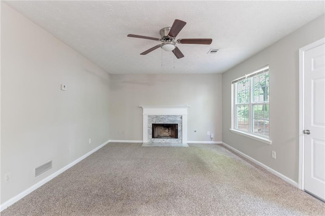 3732 Landgraf Cv, Decatur, GA 30034 - unfurnished living room featuring carpet, a high end fireplace, ceiling fan, baseboards, and a textured ceiling