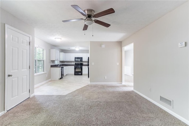 3732 Landgraf Cv, Decatur, GA 30034 - unfurnished living room featuring light colored carpet, baseboards, a textured ceiling, and ceiling fan