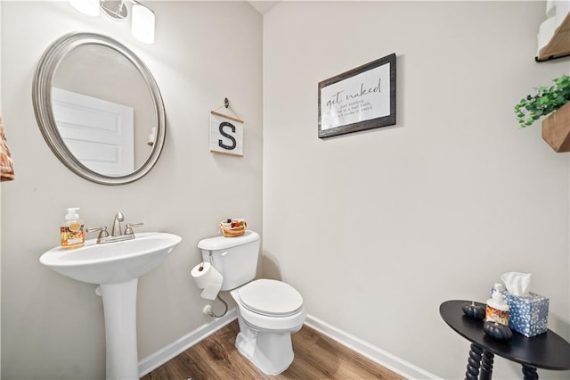 bathroom featuring sink, toilet, and hardwood / wood-style flooring