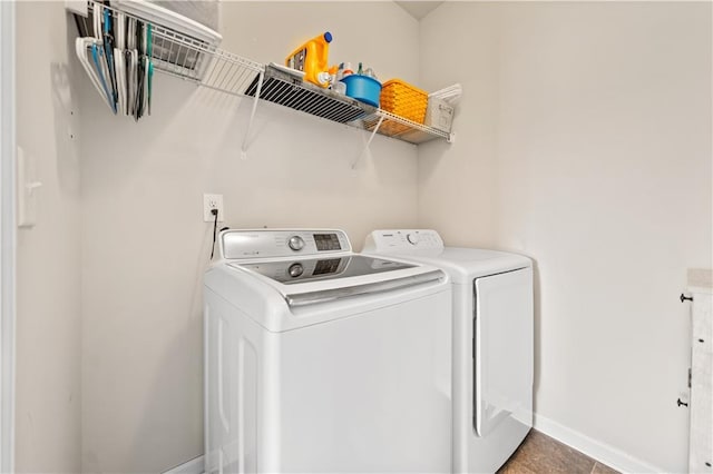 clothes washing area featuring tile patterned floors and washer and dryer