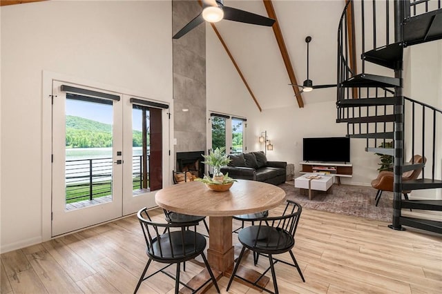 834 Lower Bell Creek Rd, Hiawassee, GA 30546 - dining area featuring high vaulted ceiling, a ceiling fan, light wood finished floors, stairway, and french doors