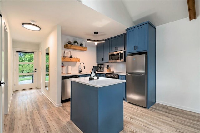 834 Lower Bell Creek Rd, Hiawassee, GA 30546 - kitchen with stainless steel appliances, light countertops, blue cabinets, light wood-style floors, and a center island