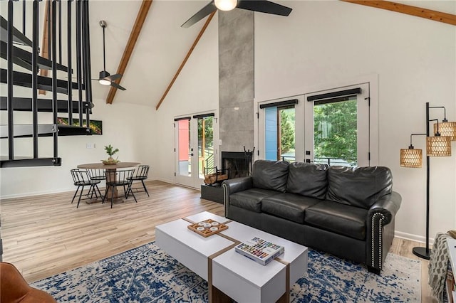834 Lower Bell Creek Rd, Hiawassee, GA 30546 - living area with high vaulted ceiling, a ceiling fan, beam ceiling, wood finished floors, and a fireplace