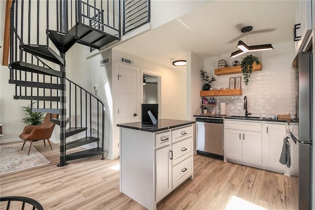 834 Lower Bell Creek Rd, Hiawassee, GA 30546 - kitchen featuring appliances with stainless steel finishes, light wood-type flooring, and dark countertops
