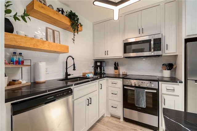 834 Lower Bell Creek Rd, Hiawassee, GA 30546 - kitchen with open shelves, appliances with stainless steel finishes, dark countertops, and decorative backsplash