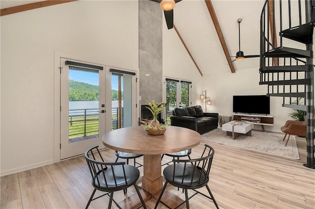 834 Lower Bell Creek Rd, Hiawassee, GA 30546 - dining room featuring french doors, high vaulted ceiling, beamed ceiling, light wood-type flooring, and healthy amount of natural light