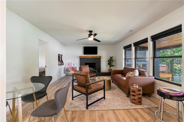 834 Lower Bell Creek Rd, Hiawassee, GA 30546 - living area featuring a ceiling fan, light wood-style flooring, and a fireplace