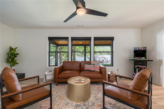 834 Lower Bell Creek Rd, Hiawassee, GA 30546 - living area with healthy amount of natural light, a ceiling fan, and light wood-style floors