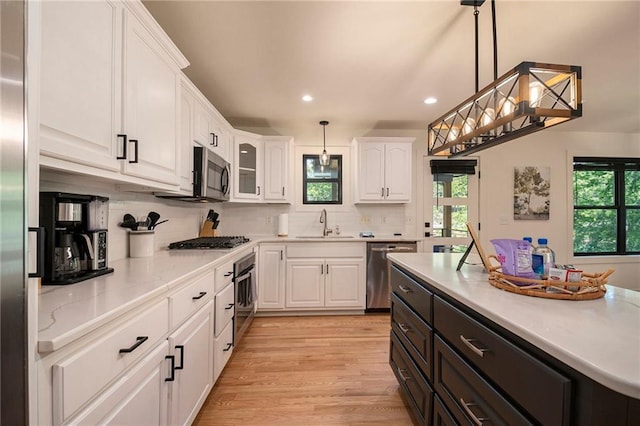 834 Lower Bell Creek Rd, Hiawassee, GA 30546 - kitchen featuring appliances with stainless steel finishes, white cabinets, plenty of natural light, recessed lighting, and backsplash