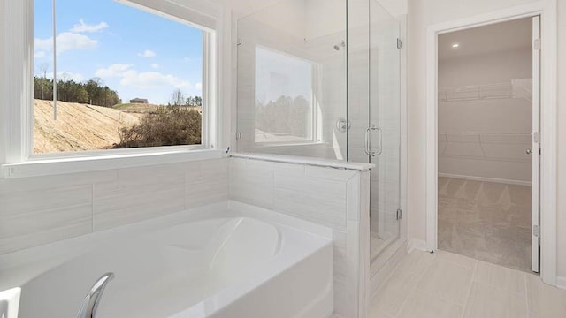 bathroom with shower with separate bathtub