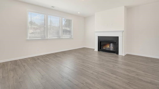 unfurnished living room with hardwood / wood-style flooring