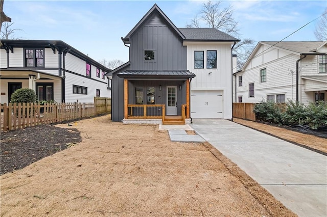 modern inspired farmhouse featuring a porch and a garage