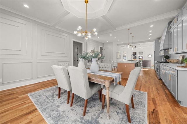 dining space featuring crown molding, a chandelier, coffered ceiling, beamed ceiling, and light wood-type flooring