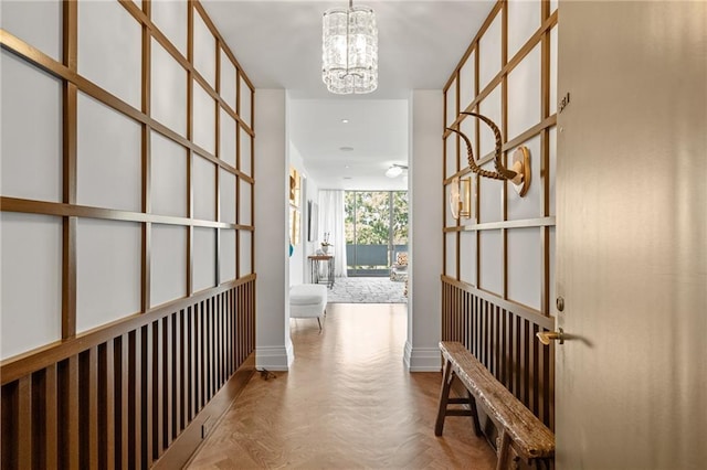 corridor featuring a chandelier and light parquet floors