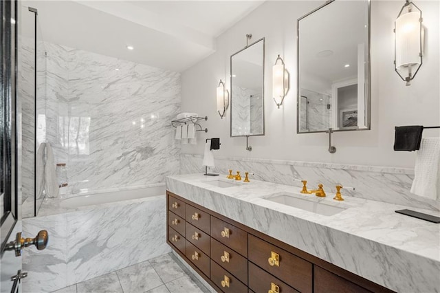 bathroom featuring vanity and tile walls