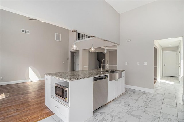 kitchen with visible vents, baseboards, appliances with stainless steel finishes, marble finish floor, and a sink