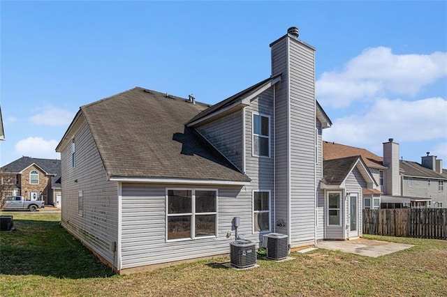 back of house featuring a yard, a patio, fence, and central air condition unit