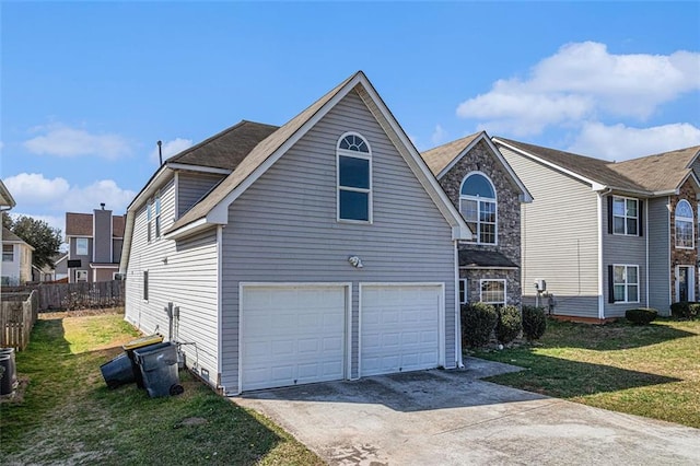 view of side of home featuring an attached garage, fence, a lawn, and concrete driveway