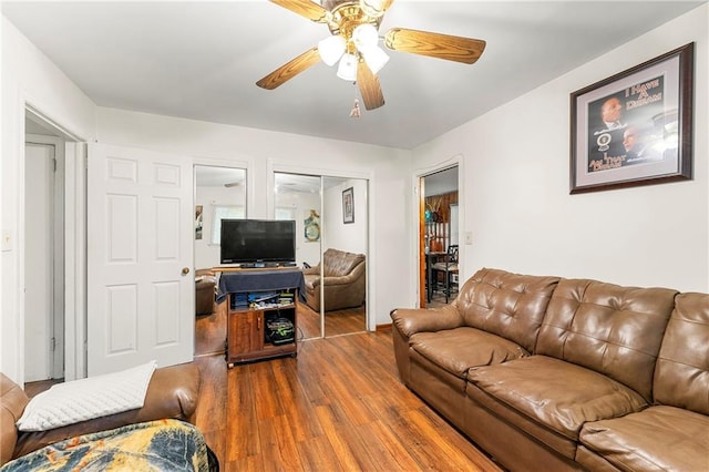 living room featuring hardwood / wood-style flooring and ceiling fan