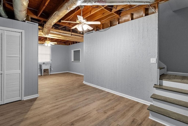 basement with ceiling fan and wood-type flooring