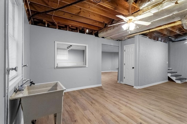 basement with light hardwood / wood-style flooring