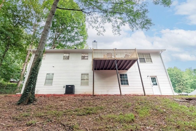 back of property featuring a balcony and cooling unit