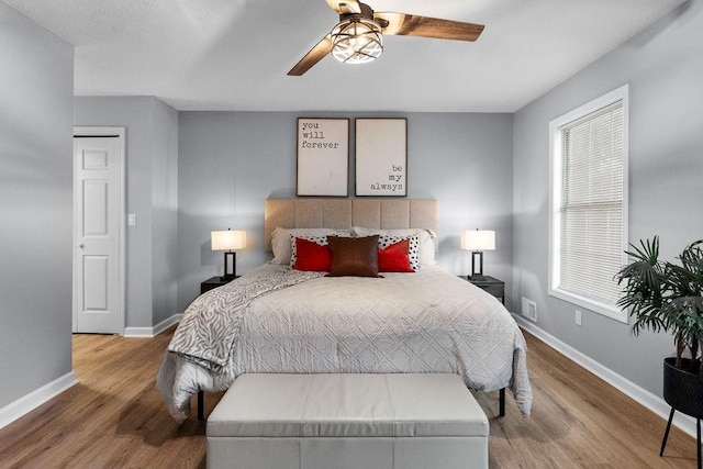 bedroom with ceiling fan and wood-type flooring