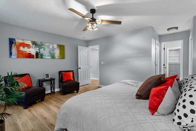 bedroom with light hardwood / wood-style floors and ceiling fan