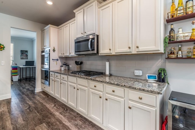 kitchen featuring appliances with stainless steel finishes, dark wood-type flooring, white cabinetry, and tasteful backsplash