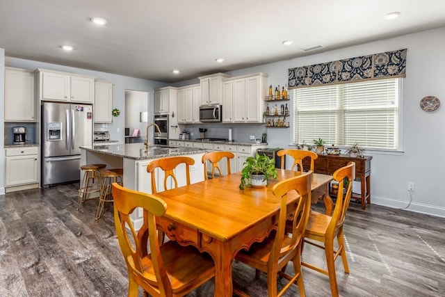 dining space with dark wood-type flooring, recessed lighting, visible vents, and baseboards