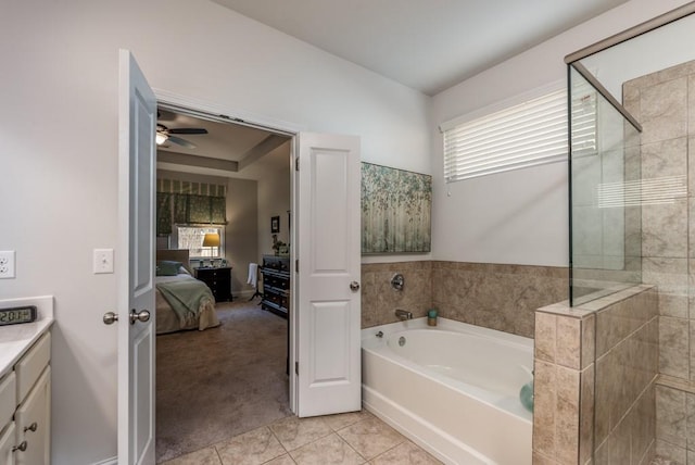 ensuite bathroom with connected bathroom, tile patterned flooring, vanity, a tile shower, and a bath