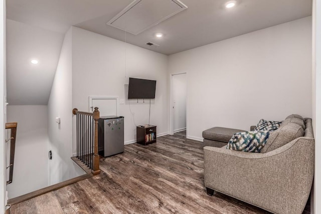 living room featuring recessed lighting, visible vents, attic access, wood finished floors, and baseboards