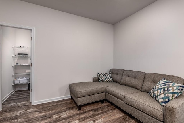 living area with baseboards and dark wood-style flooring