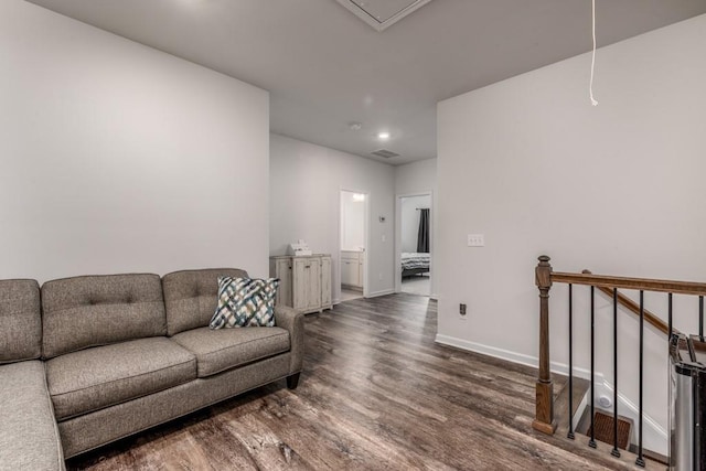 living room with recessed lighting, visible vents, attic access, wood finished floors, and baseboards