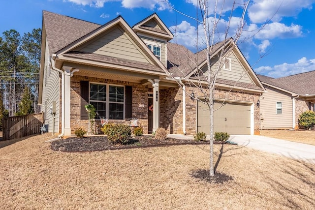 view of front of property featuring a porch, an attached garage, brick siding, driveway, and roof with shingles