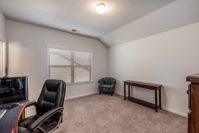 office area with light carpet, vaulted ceiling, visible vents, and baseboards