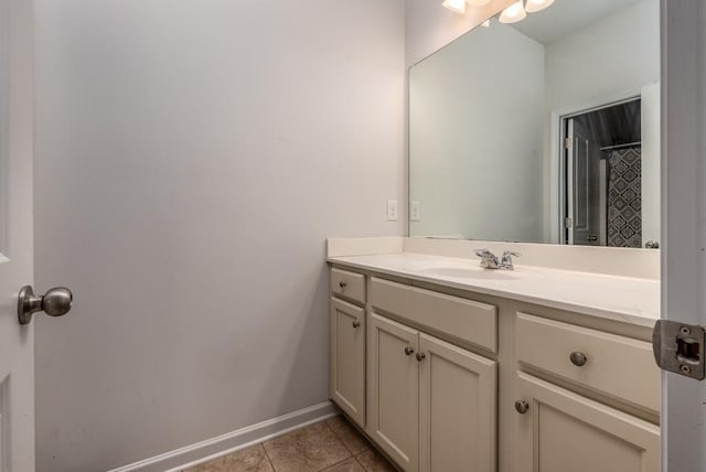 bathroom featuring tile patterned flooring, vanity, and baseboards