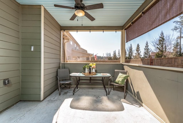 view of patio / terrace with ceiling fan and fence